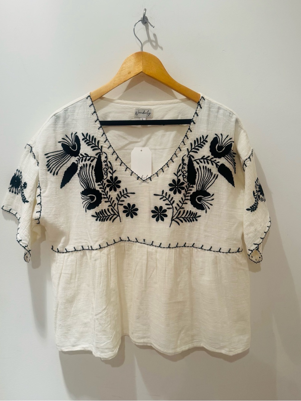 Wonderly cotton V-Neck White Top with Black Floral embroidered details. Size L.